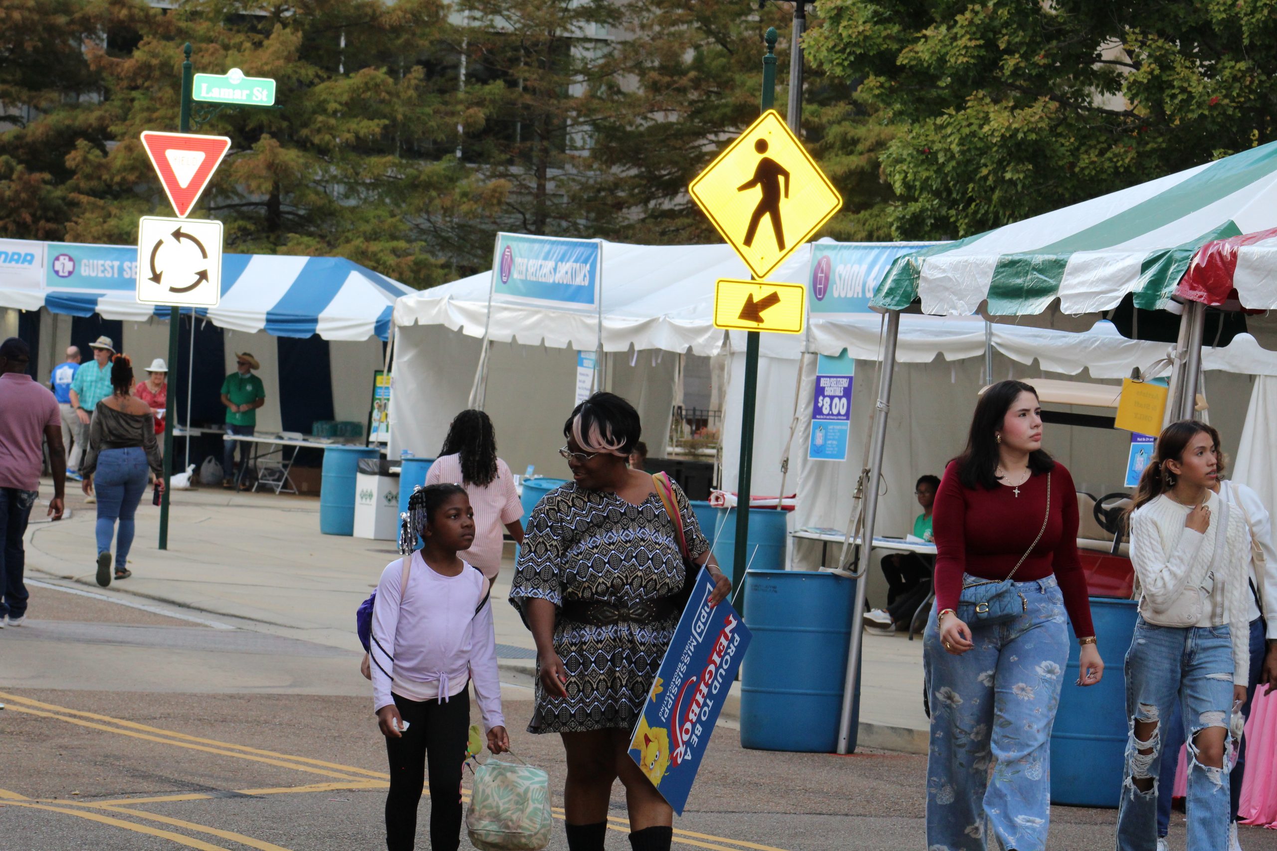 Candidate speaking with a gathered crowd at an evening community event.